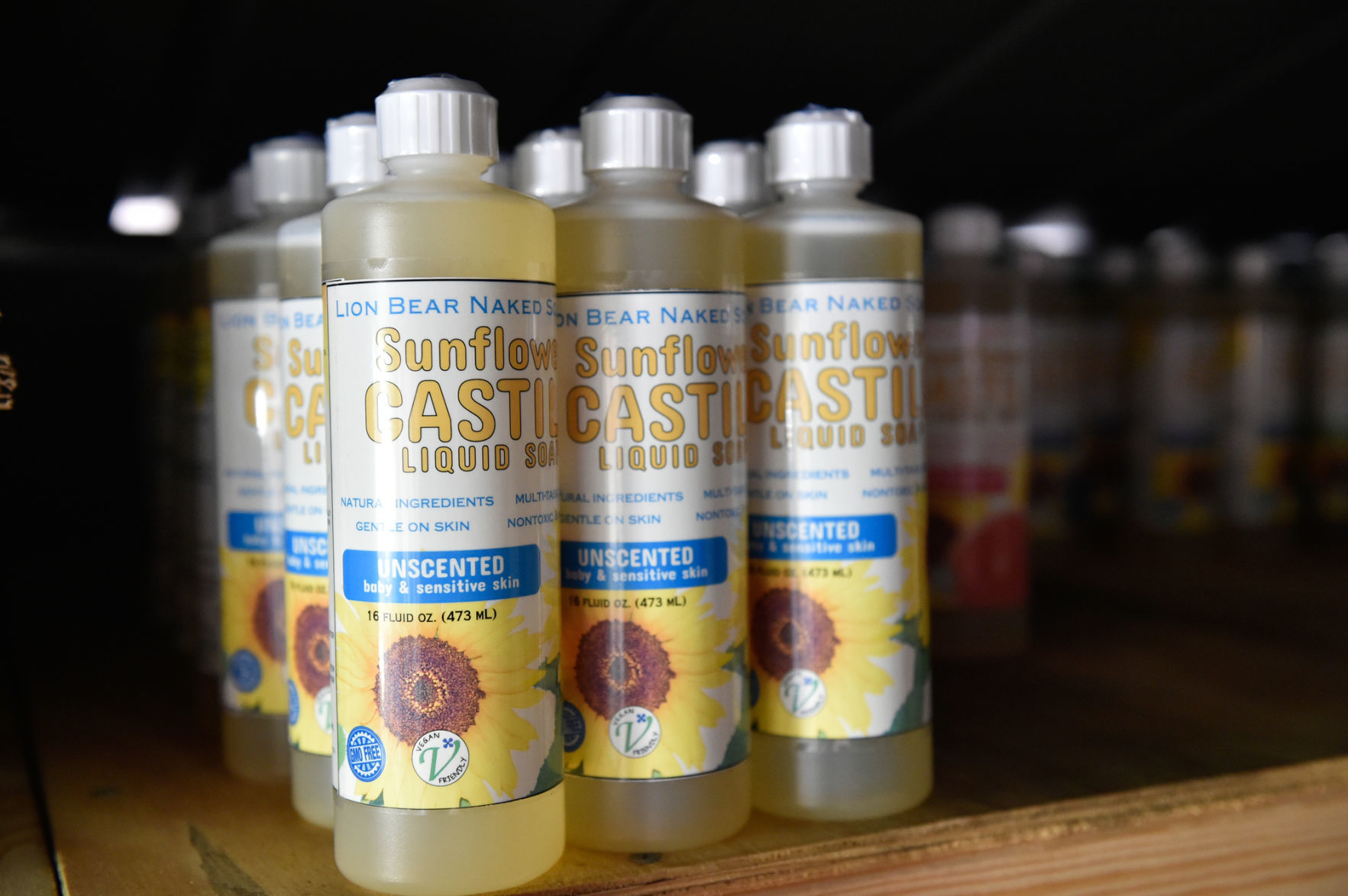 A closer look at some bottles of Lion Bear Naked Soap Co. sunflower castile liquid soap. The company manufactures a full line of multi-use soaps, body washes, spray cleaners, and laundry powder. Every product is a nontoxic, vegan, grey water safe, nut oil